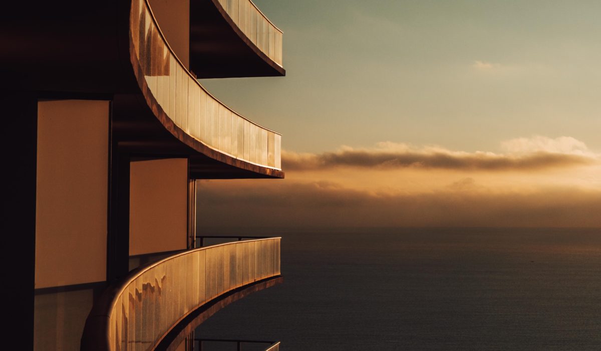 [gpt-4o]: Curved building balconies facing a sunset over the ocean